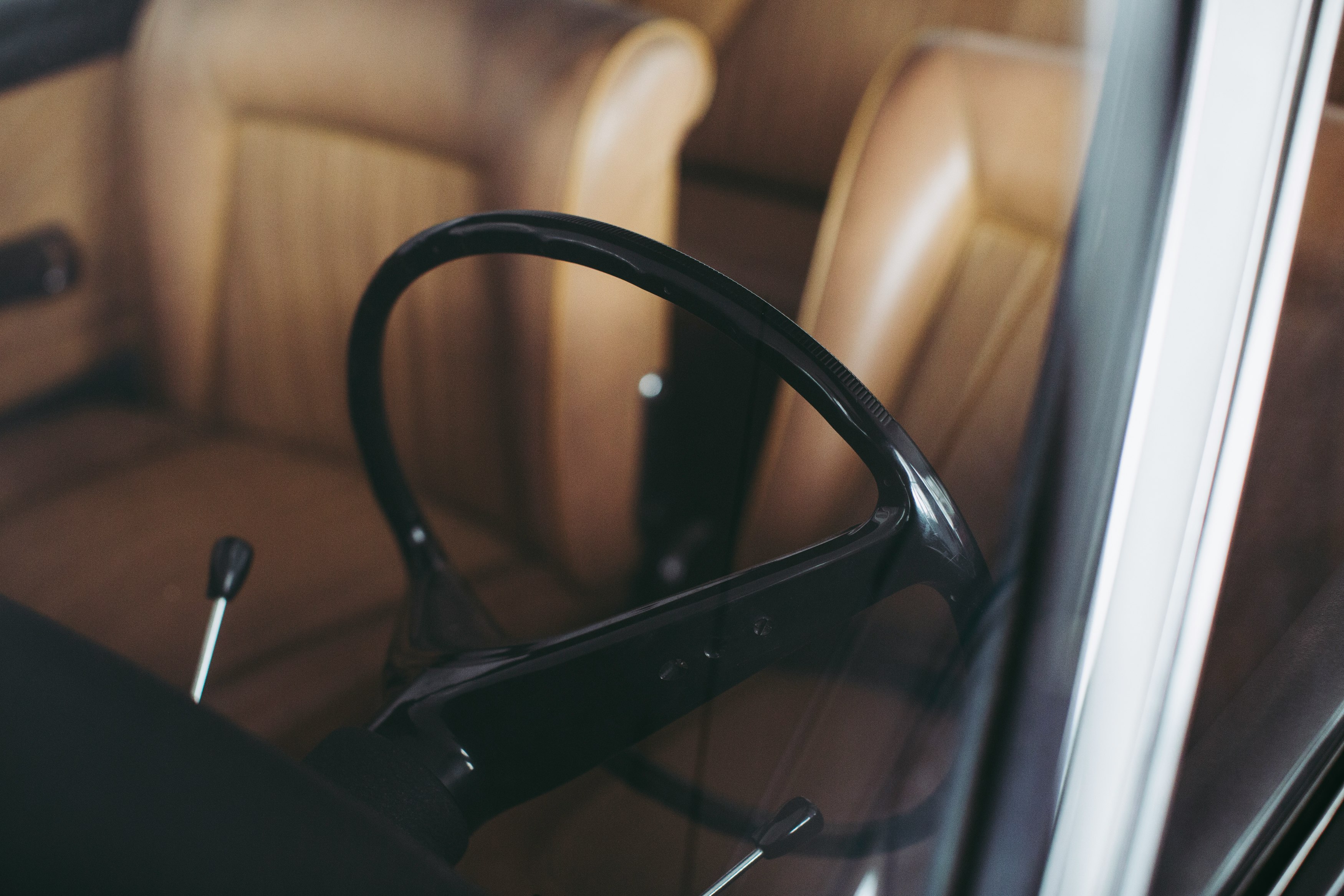 black car steering wheel in close up photography